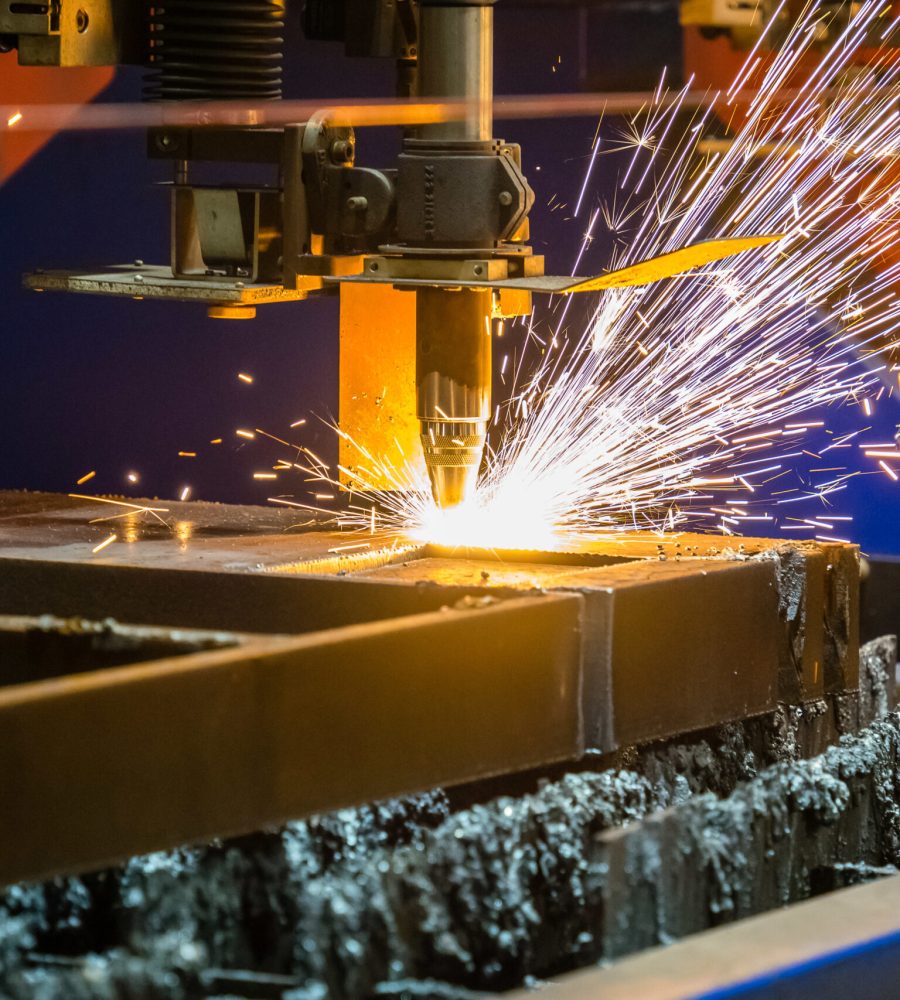 A closeup shot of sparks flying from an industrial steel cutter